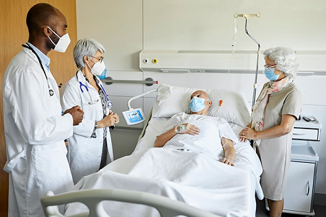 Doctors attending to a patient in a hospital.